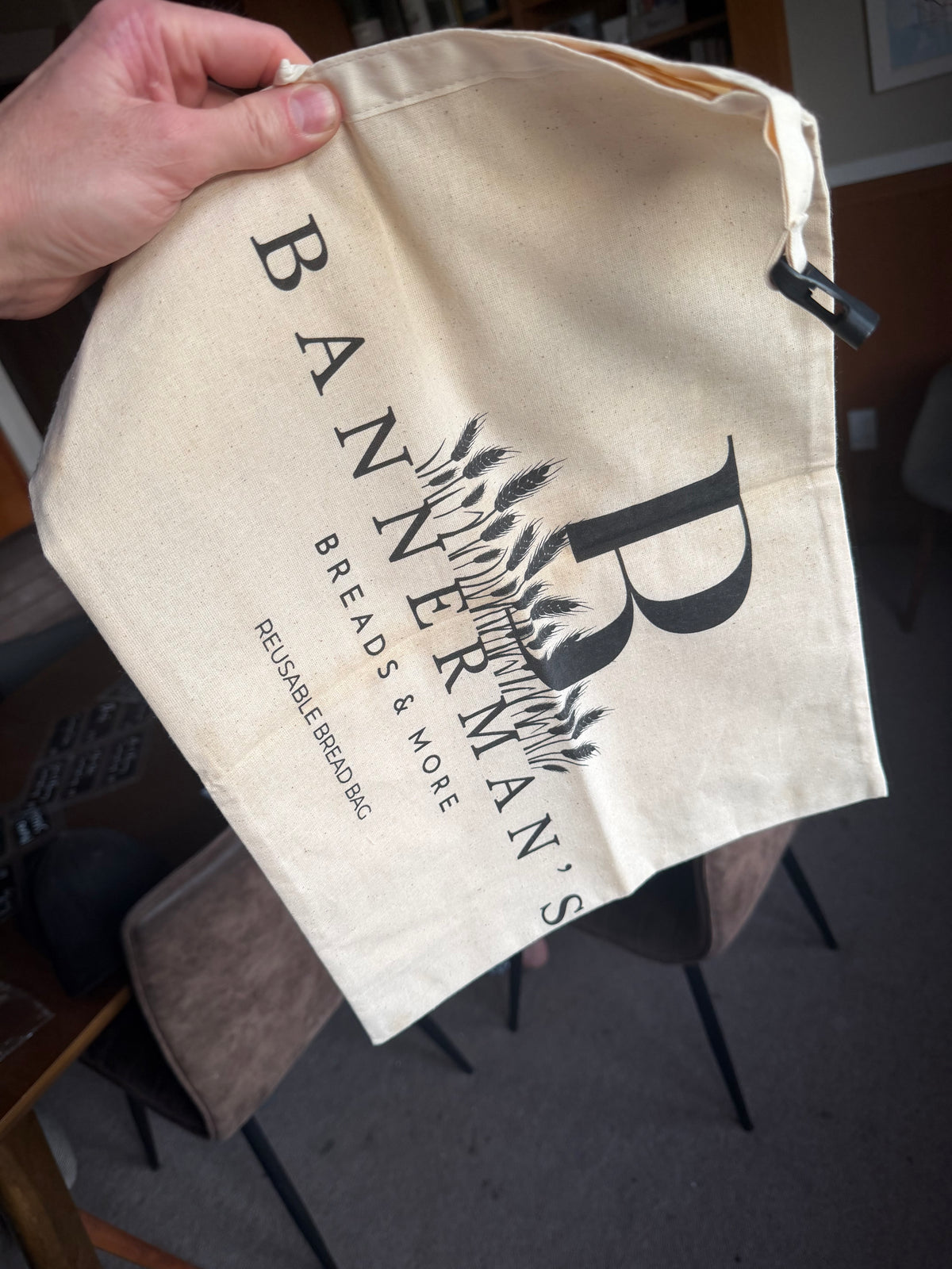 Close-up of Bannerman's reusable beeswax bread bag with roll-down closure
